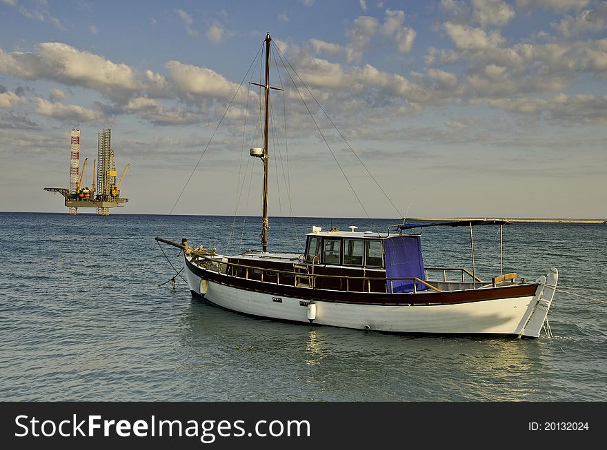 This is an oil rig outside of Limassol and a traditional, old sailboat. This is an oil rig outside of Limassol and a traditional, old sailboat