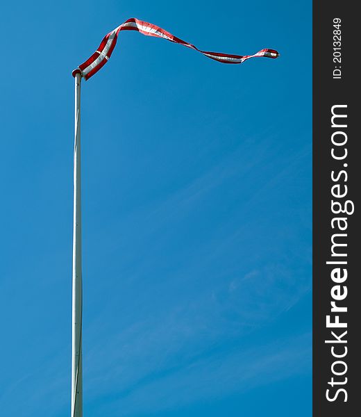 Flag of Denmark up high with clear blue sky background vertical image. Flag of Denmark up high with clear blue sky background vertical image