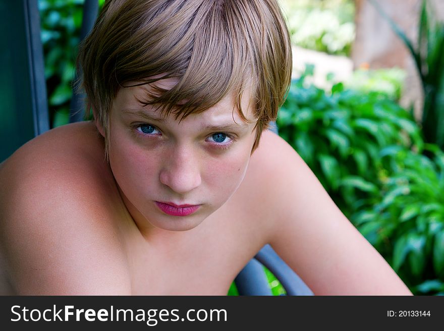 Portrait of teenage boy on the grass background