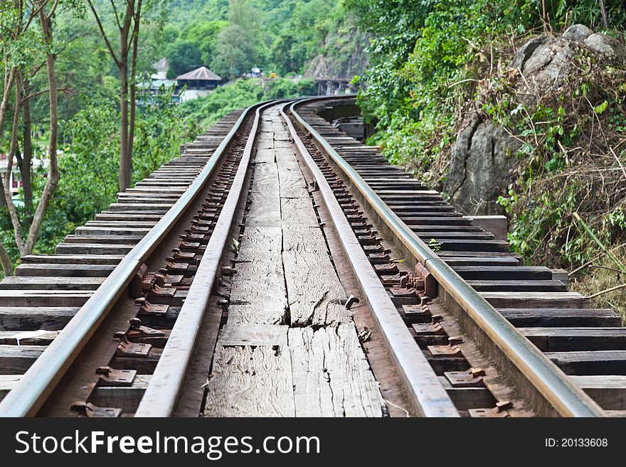 Curve train rails with a forest as background