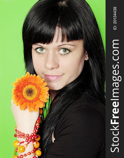 Beautiful woman in the bracelet holds to gerbera. Beautiful woman in the bracelet holds to gerbera