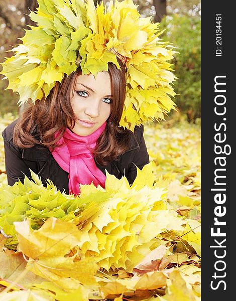 Beautiful woman in the wreath from yellow leaves. Beautiful woman in the wreath from yellow leaves