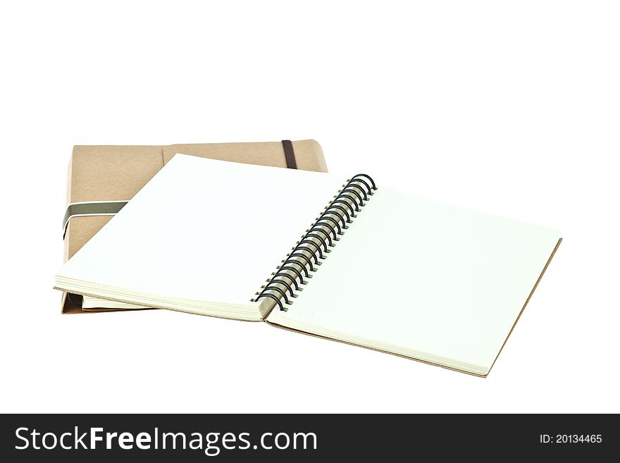 Isolated Light cream color paper note book on brown book. Isolated Light cream color paper note book on brown book