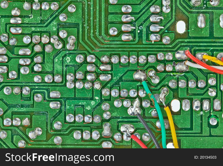 The printed-circuit board with electronic components macro background