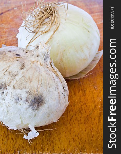 Closeup of two bulbs of onion on the table