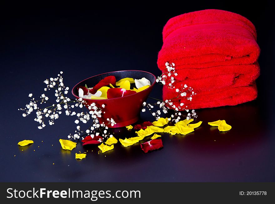 Red towels with flower and candle on black background. Red towels with flower and candle on black background