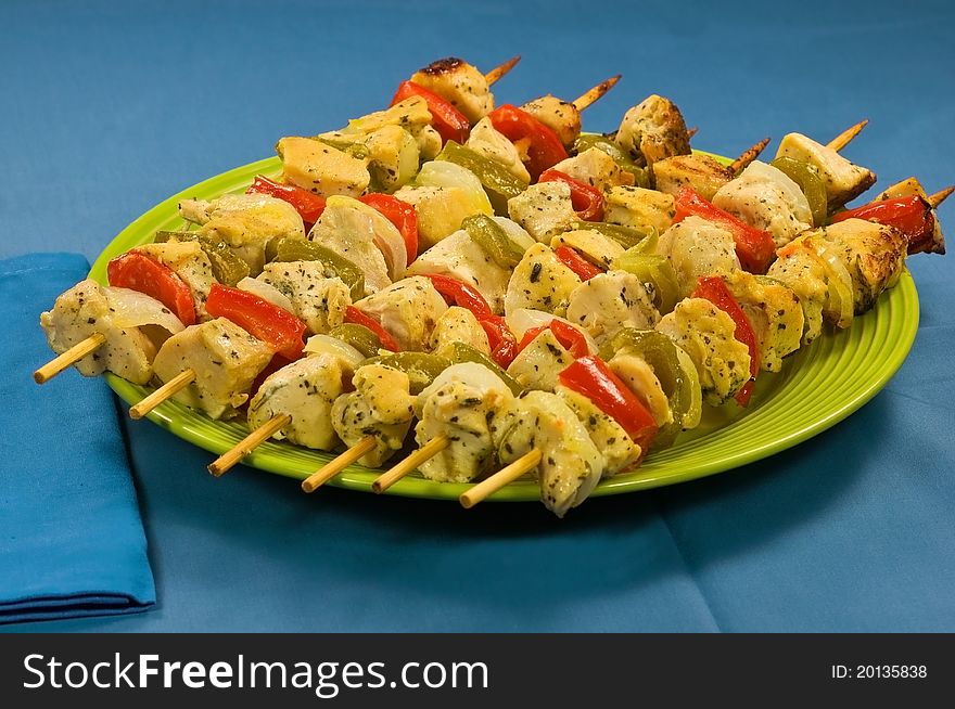 Plate of baked chicken on skewers. Plate of baked chicken on skewers