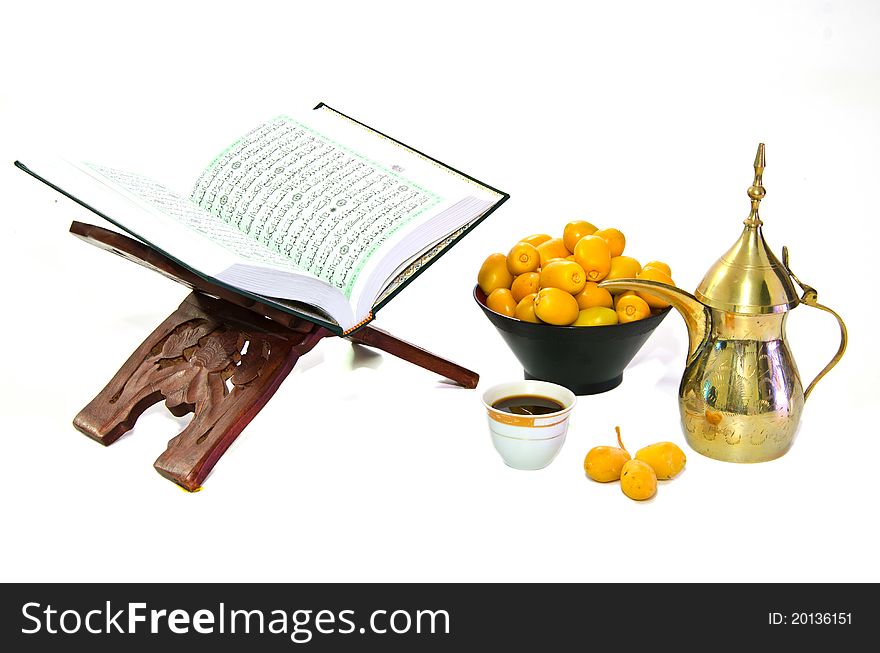 Arabic Coffee with Dates Fruit and the Holy Quran isolated on white Background. Arabic Coffee with Dates Fruit and the Holy Quran isolated on white Background