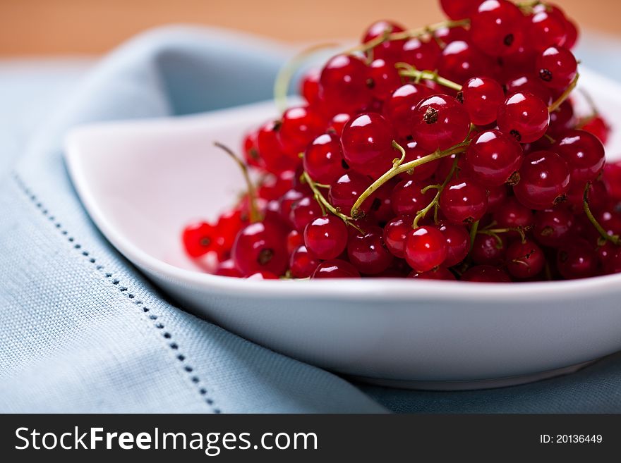 Closeup of red currant in a white bowl