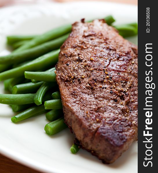 Closeup of beefsteak on french beans. Closeup of beefsteak on french beans