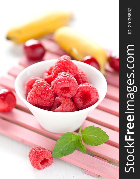 Fresh raspberries in bowl with mint