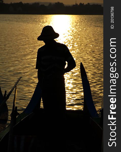 Burmese old man row wooden boat in Myanma