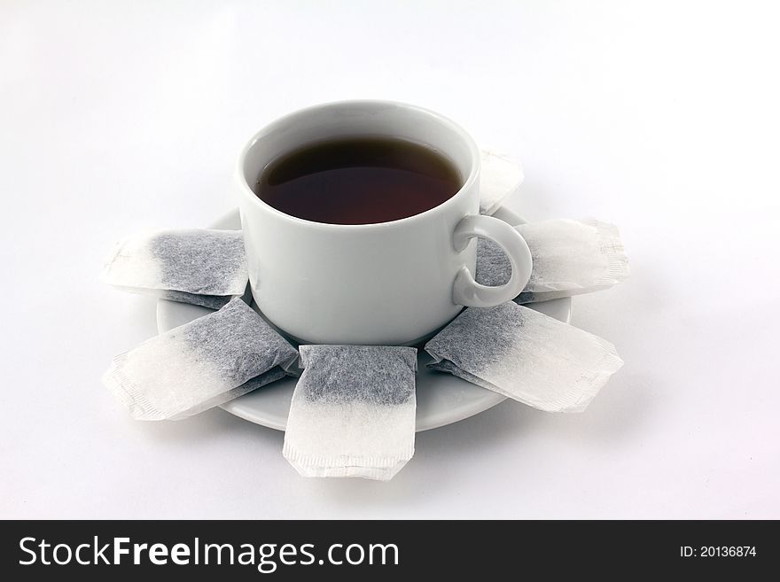 A cup of tea with teabags isolated on white