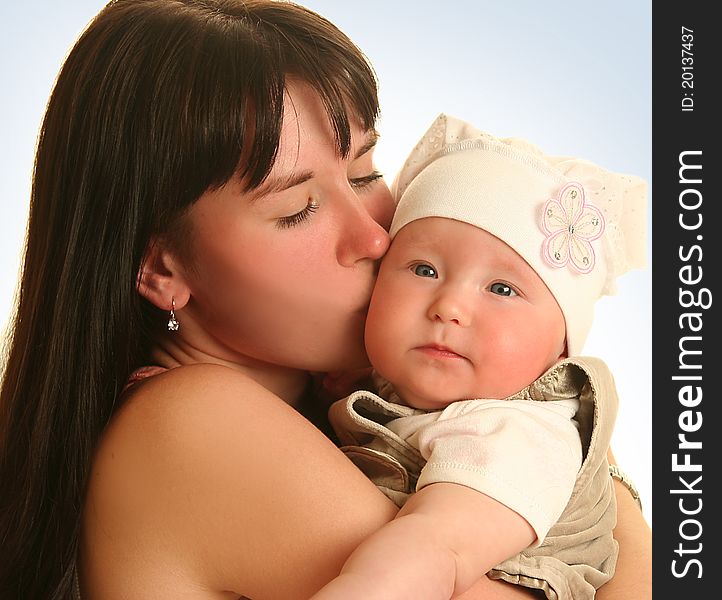 Young mother with baby on blue background. Young mother with baby on blue background