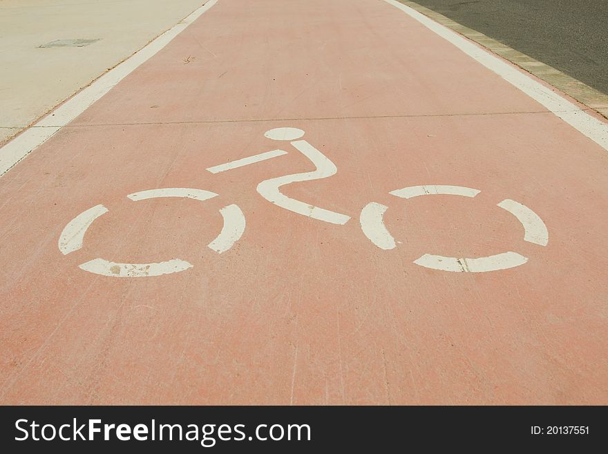 A clearly marked cycle path running alongside a road