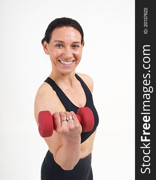 Middle aged woman with weights staying in shape. Middle aged woman with weights staying in shape