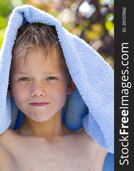 A young child in nature with towel