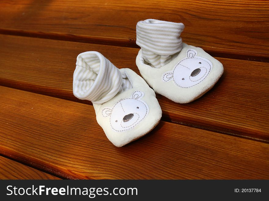Baby white shoes on wood. Baby white shoes on wood