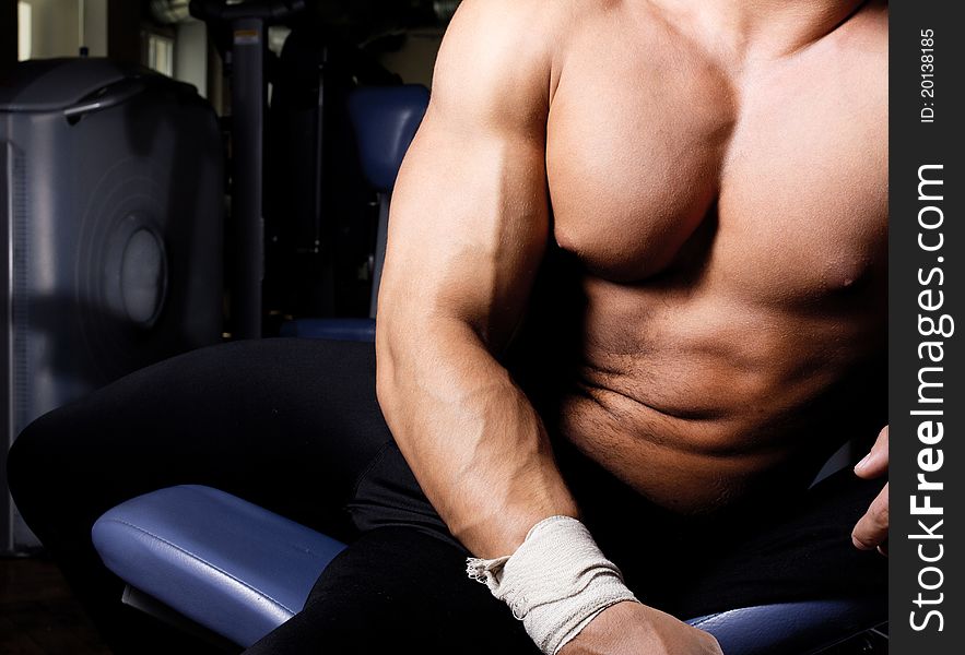 Muscular body in gym room. Muscular body in gym room