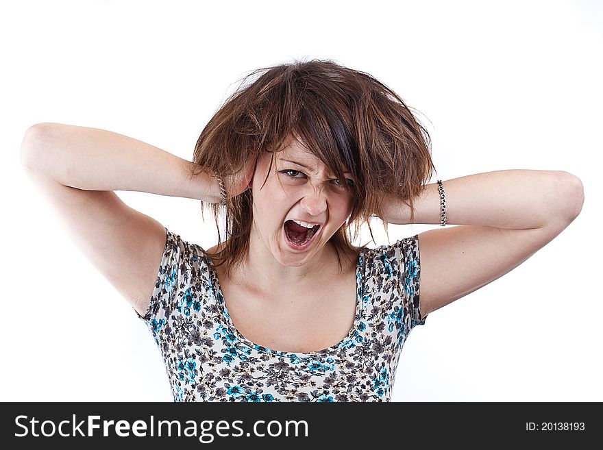 Angry woman is screaming out loud and pulling her hair.