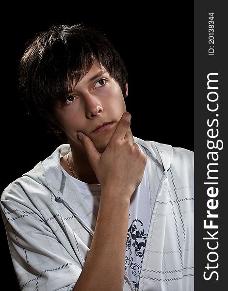 Young man thinking, black background. Young man thinking, black background