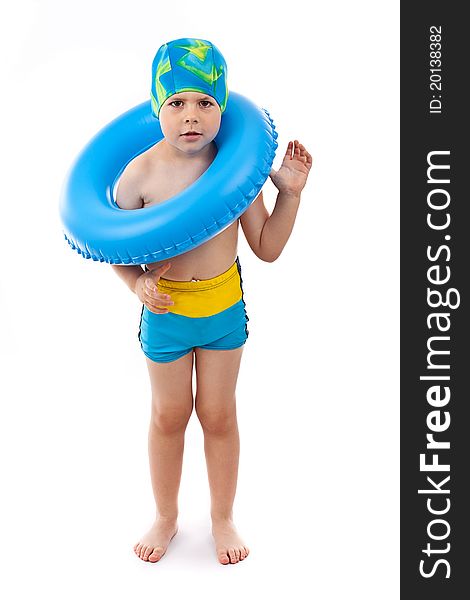 Funny little boy playing with blue life ring in swim caps