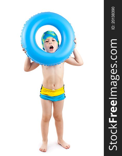 Funny little boy playing with blue life ring in swim caps, looking