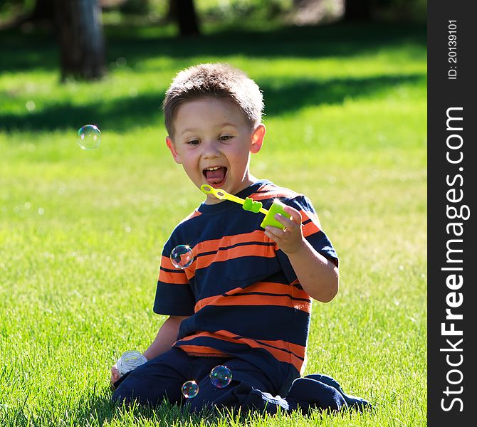 Little boy looking on soap bubbles