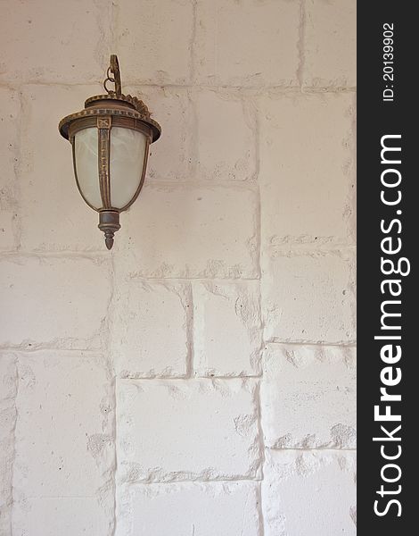 Antique wall-lamp on white rough wall. Antique wall-lamp on white rough wall