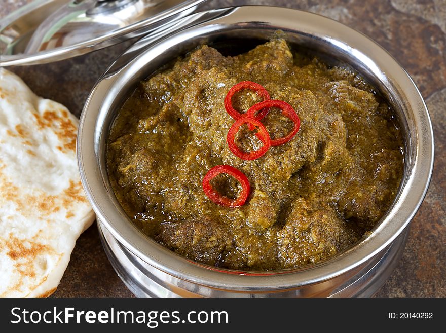 Lamb korma Indian curry in serving bowl, with naan bread. Lamb korma Indian curry in serving bowl, with naan bread.