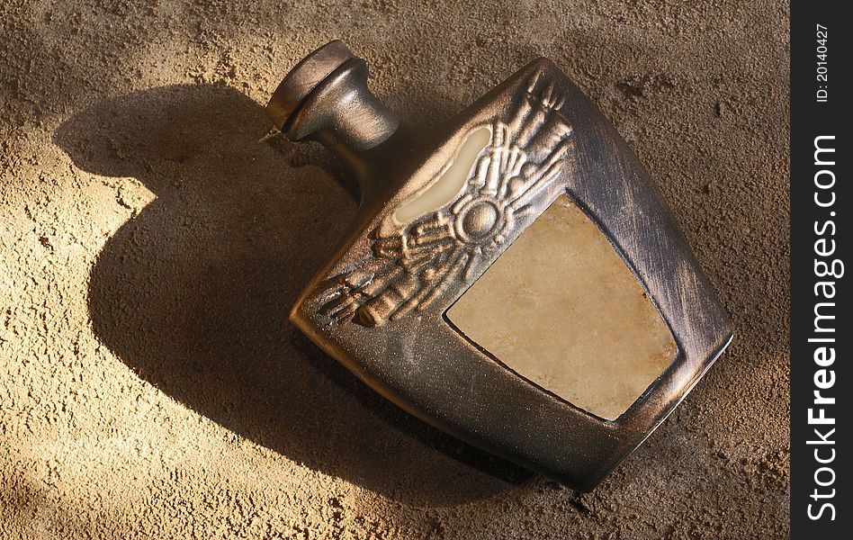 Original ceramic decanter on a sandy grount. Original ceramic decanter on a sandy grount.