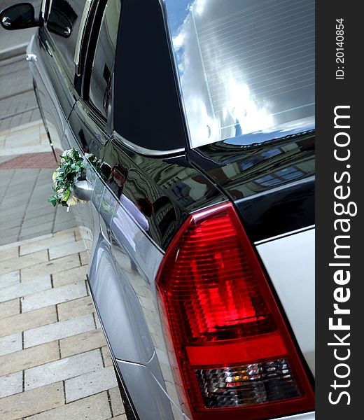 Luxury silver and black wedding limousine with bouquet on the street. Luxury silver and black wedding limousine with bouquet on the street.