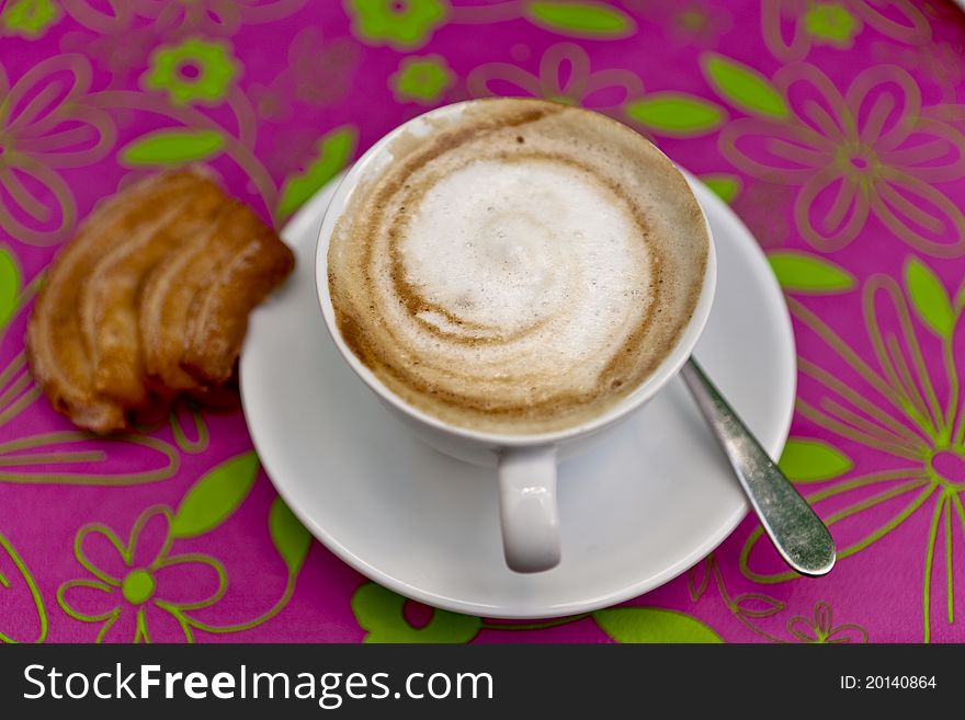 Cappuccino with cookie over coloerful background