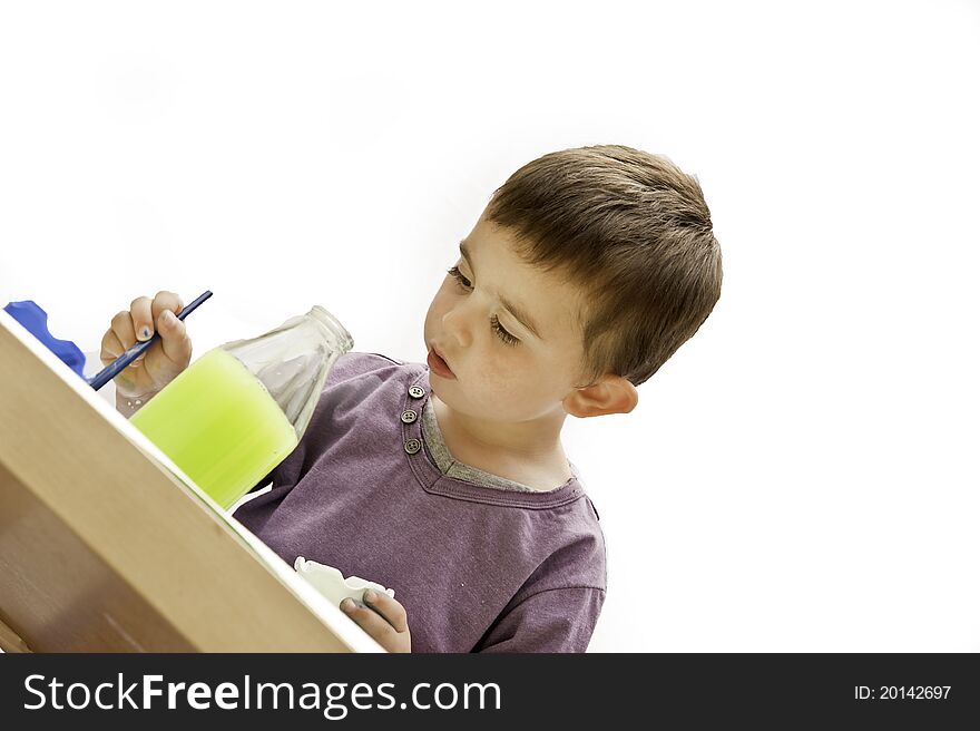 Image of a happy and content young toddler painting isolated on a white background