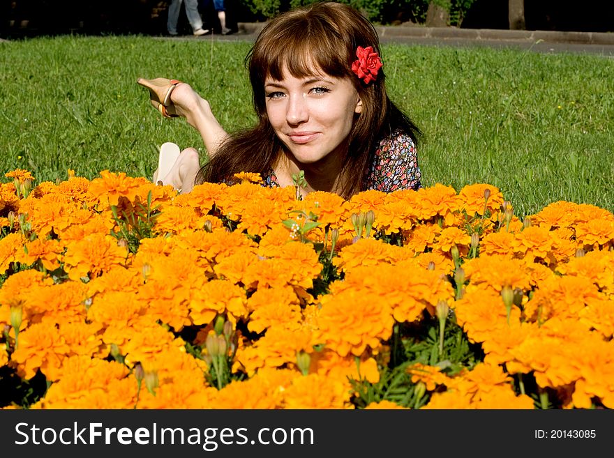 Beautiful girl lying on meadow with flowers