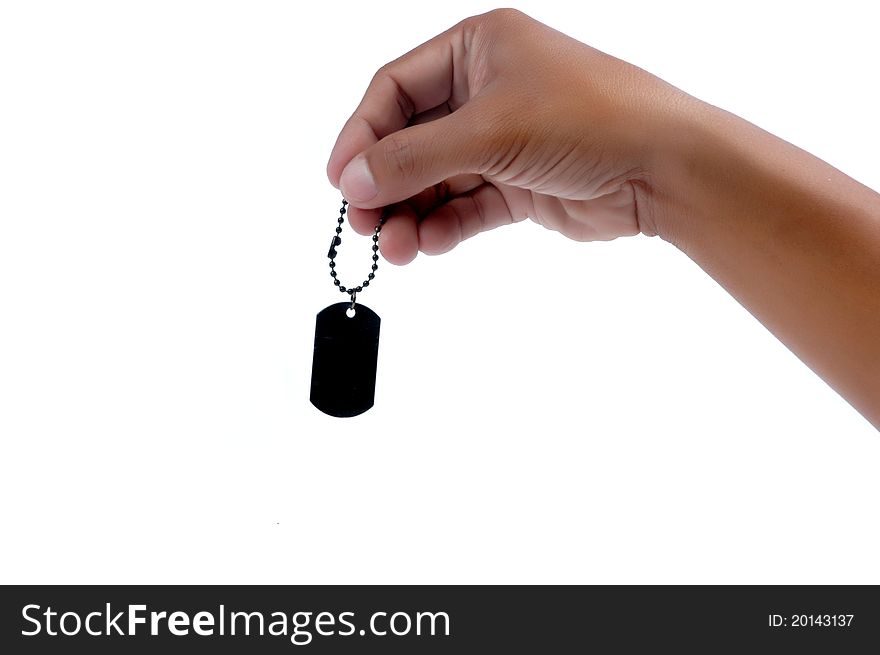 Male hand holding a black metal blank tag isolated on white background