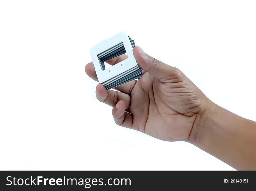 Male hand holding a pile of frames film slide isolated on white background