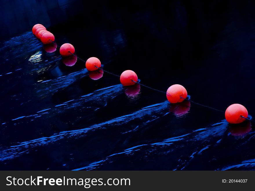 Set of red beacons on deep blue water. Set of red beacons on deep blue water