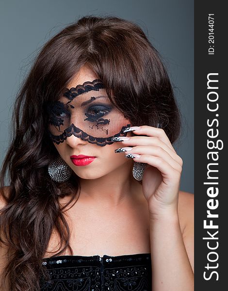 Attractive brunette with lacy mask on eyes