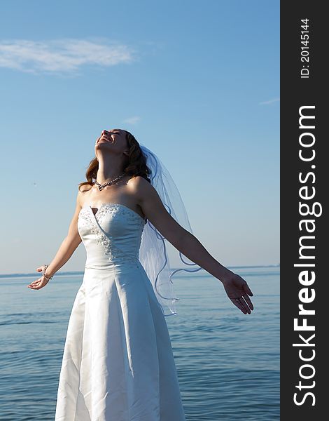 A happy bride soaking in the sun on her wedding day. A happy bride soaking in the sun on her wedding day