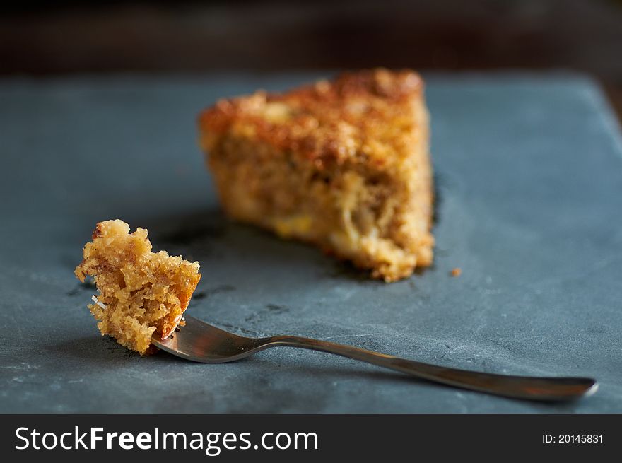 A fork with a piece of banana pecan cake. A fork with a piece of banana pecan cake