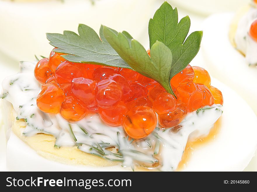 Caviar salmon species in boiled chicken egg. Caviar salmon species in boiled chicken egg