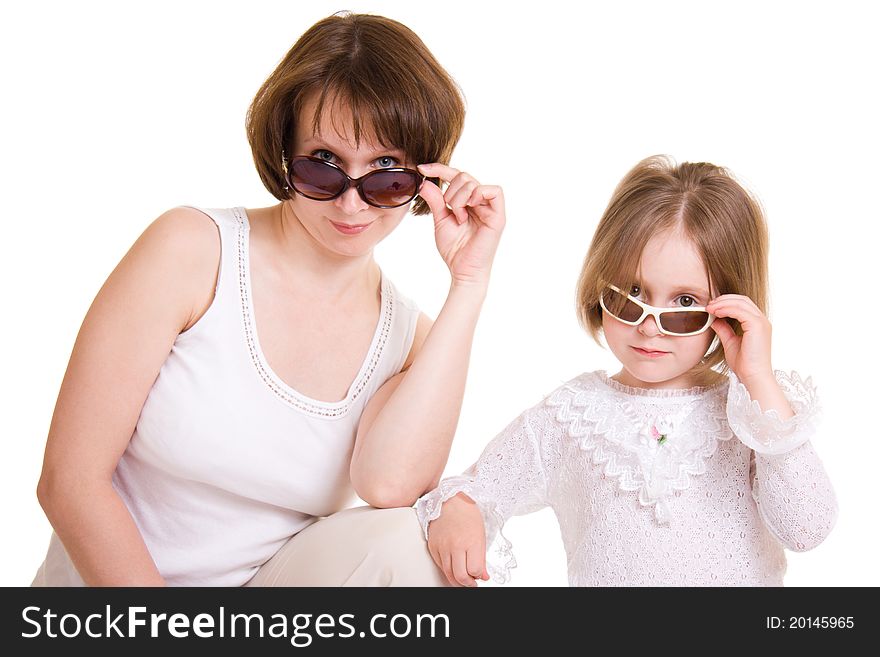 Mother and daughter in sunglasses on white background.