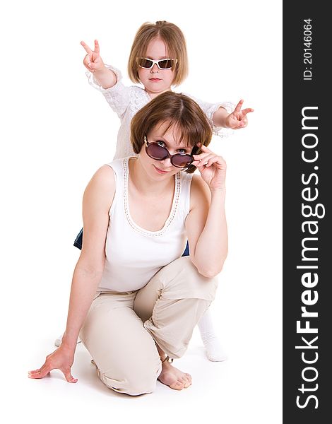 Mother and daughter in sunglasses on white background.