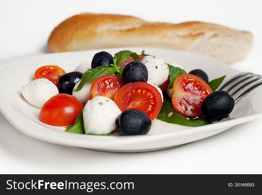 Caprese Salad with Basil, Fresh Mozzarella, Cherry Tomatos, Black Olive, Olive Oil, Crispy Baguette & Garlic. Caprese Salad with Basil, Fresh Mozzarella, Cherry Tomatos, Black Olive, Olive Oil, Crispy Baguette & Garlic