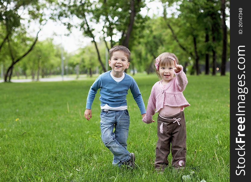 Happy sister and brother outdoors