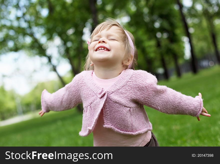 Portrait of a happy little girl in the park. Portrait of a happy little girl in the park