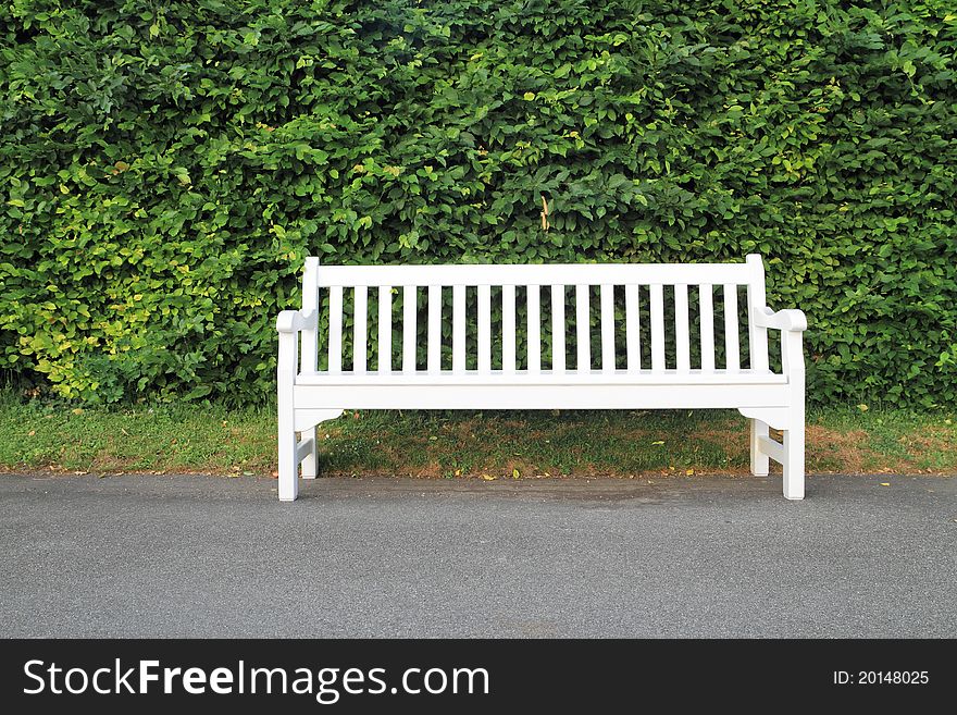 Empty white wooden bench in park. Empty white wooden bench in park