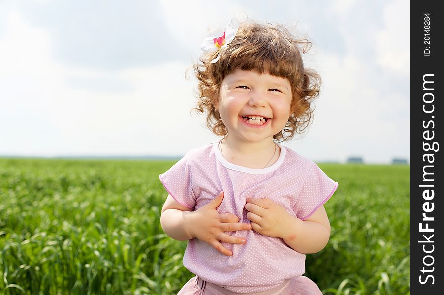 Portrait of a happy little girl outdoors in summer. Portrait of a happy little girl outdoors in summer