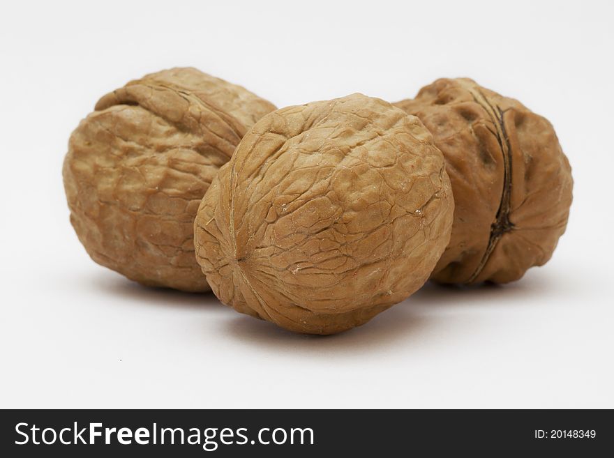 Three walnuts on a white background. Three walnuts on a white background